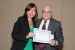 Dr. Nagib Callaos, General Chair, giving Dra. Alezandra Torres the best paper award certificate of the session "Aprendizaje y Enseñanza en Línea." The title of the awarded paper is "Una Experiencia de Educación Parental mediante Entornos Virtuales de Aprendizaje."